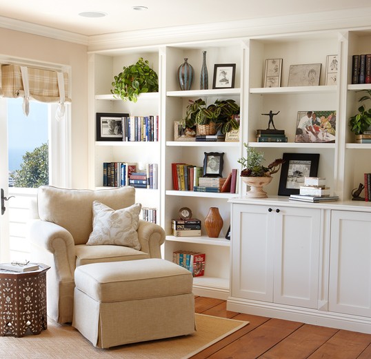 Reading nook interior designed with plush chair and ottoman to match lovely bookshelf: Laguna Beach