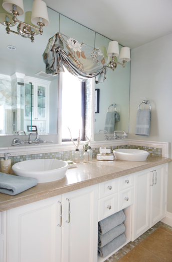 Beachfront master bathroom interior design features clean whites and sinks that come out of the mirror